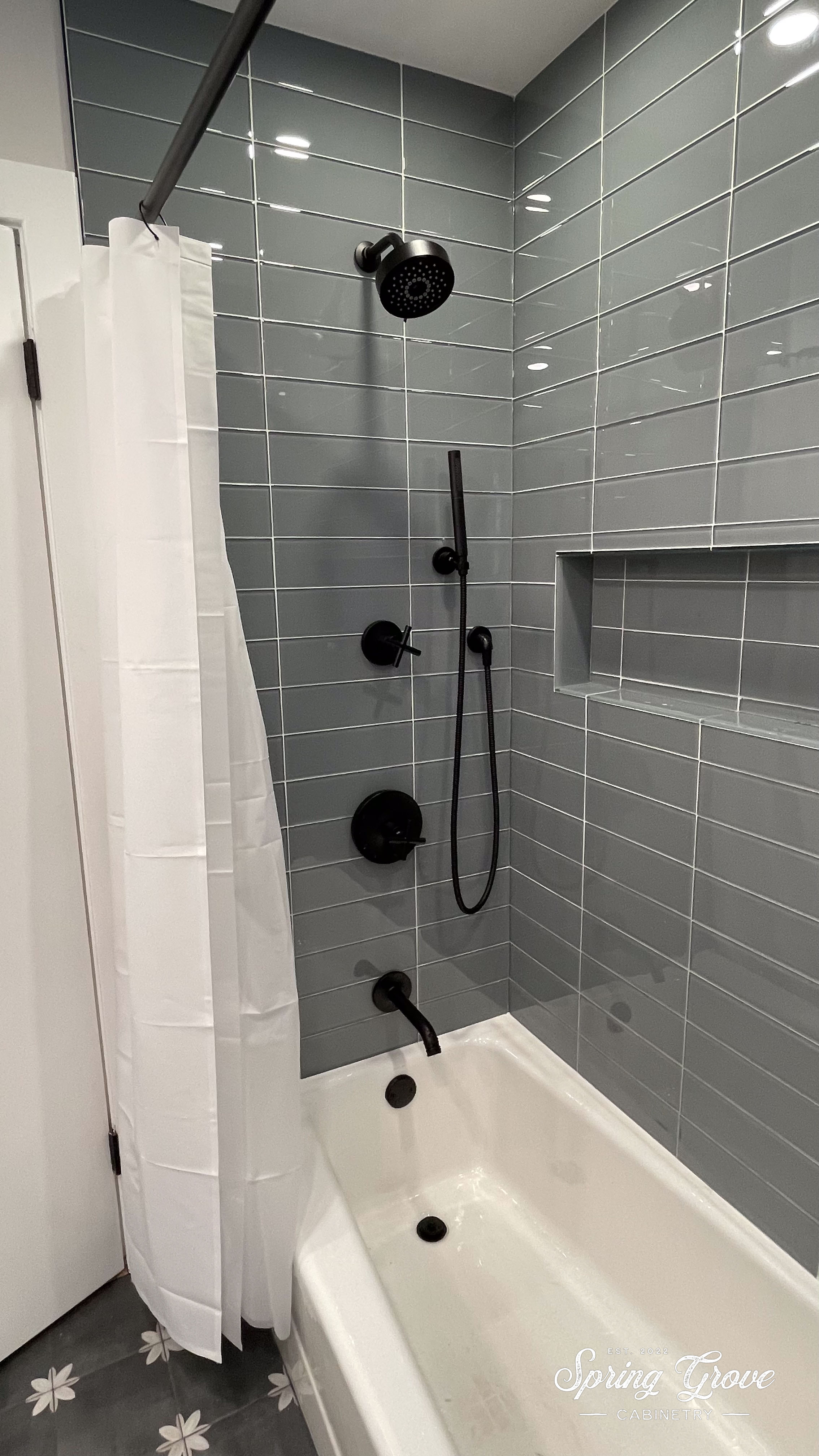 Glass tile with a wide niche for storage.