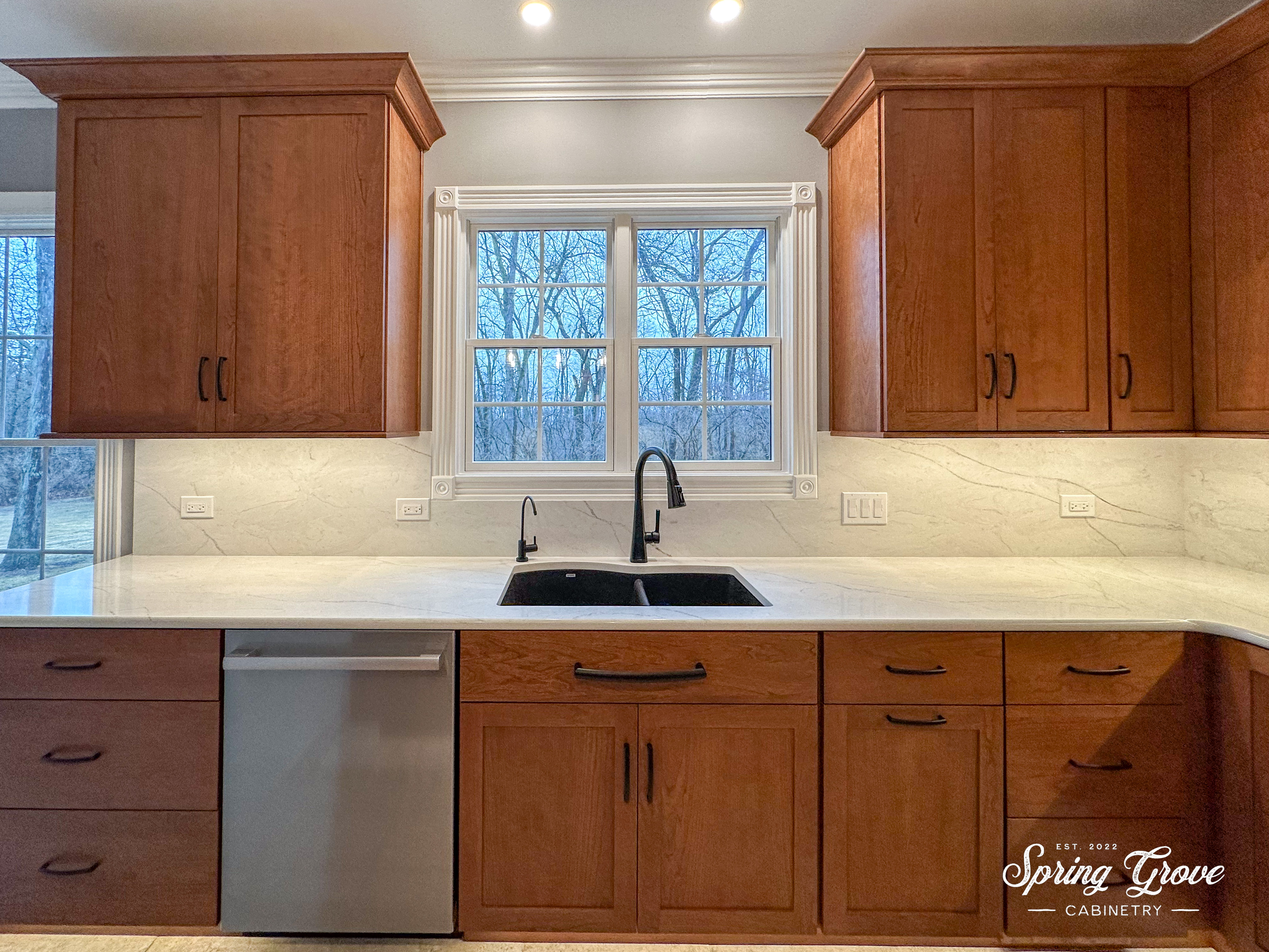 The kitchen features a full-height quartz back-splash and a Blanco Anthracite sink in black.
