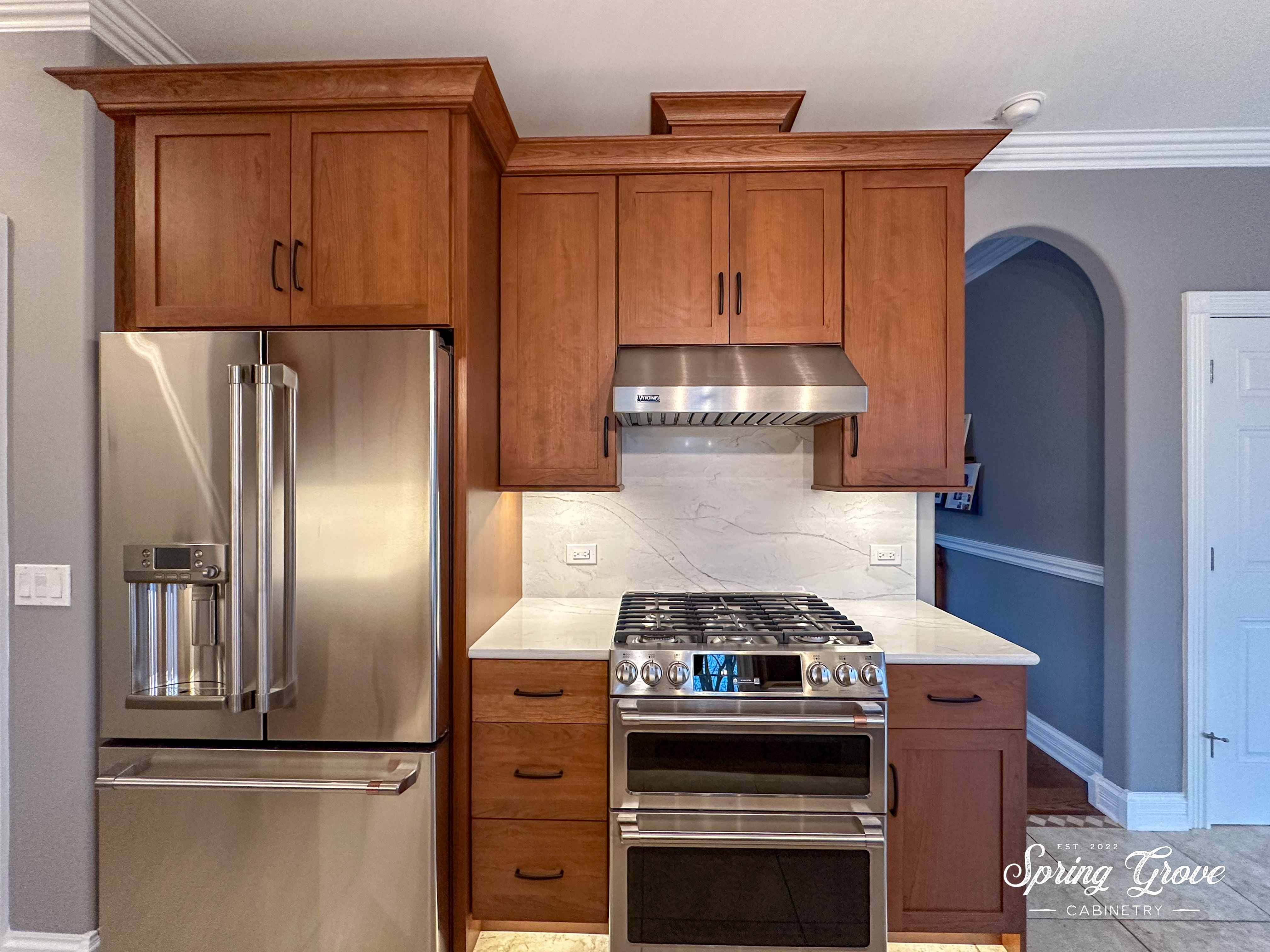 We moved the refrigerator to the location of the old double-oven. The homeowners' selected a new GE Cafe slide in-range that has double ovens built-in.