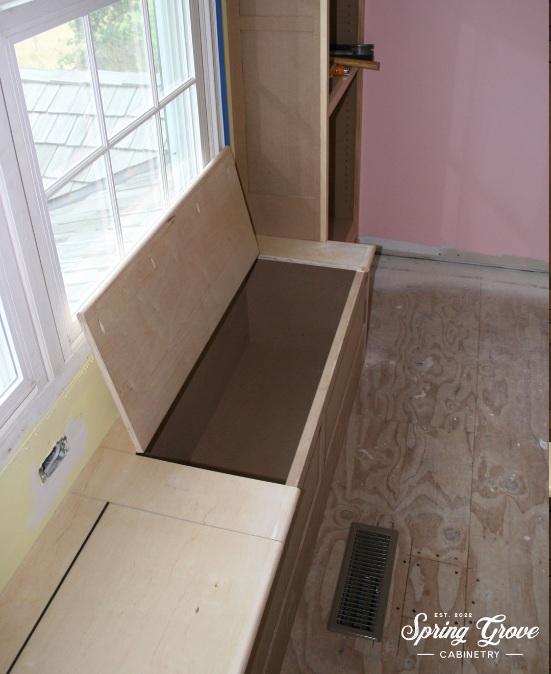 The window seat during construction. We had to relocate the heating vent and the outlet to make room for the seat.